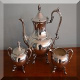 S99. Footed silver on copper teapot with matching creamer and sugar. 